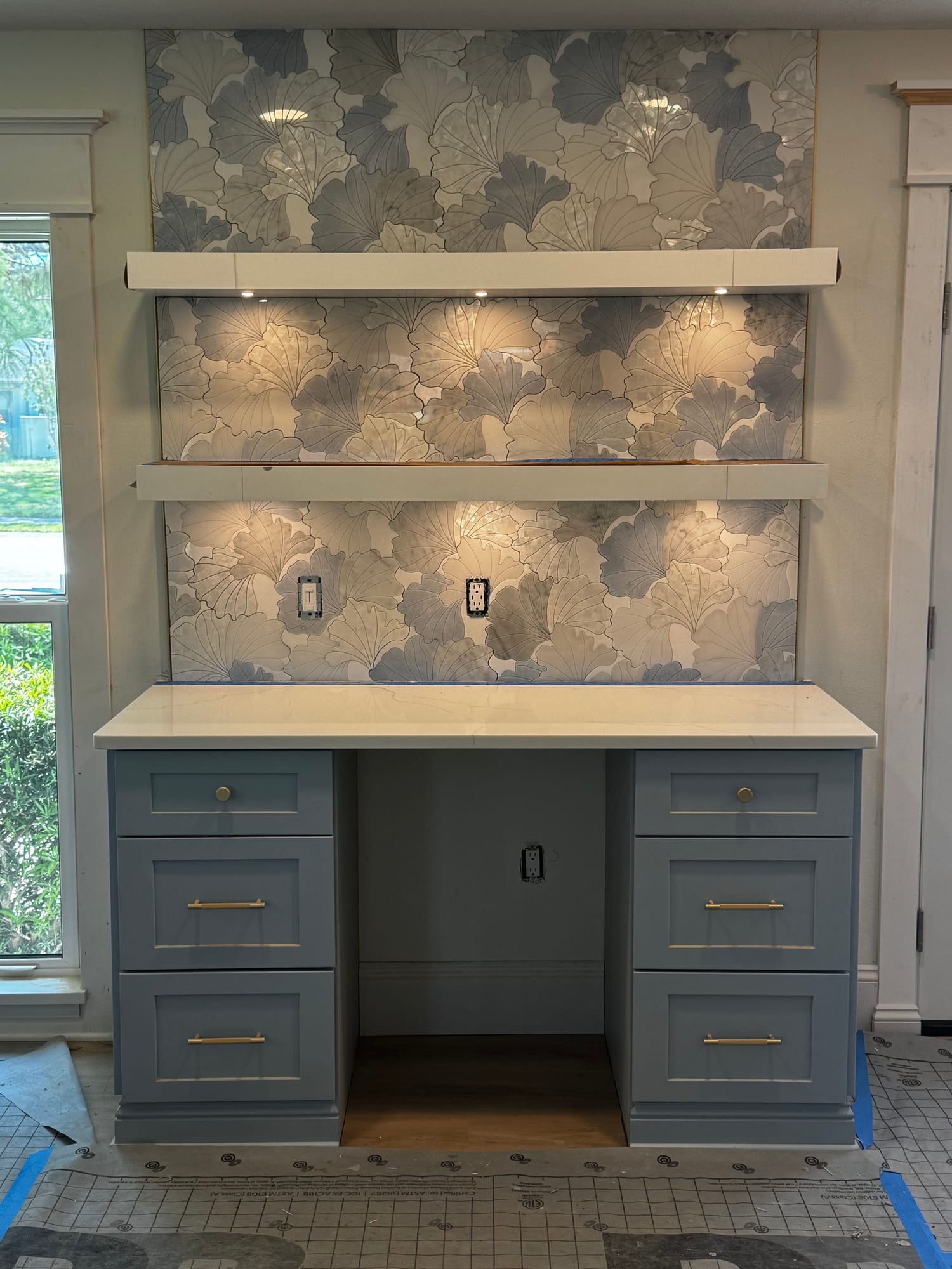 Custom built-in cabinetry with designer ginkgo tile backsplash
